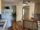 View of the kitchen featuring hardwood floors and an open view into bedroom at 533 Cervina N Dr # 773, Venice, FL 34285