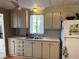 Kitchen showing the sink, a window, white cabinets and laminate countertops at 533 Cervina N Dr # 773, Venice, FL 34285