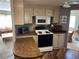 Bright kitchen featuring an oven, microwave, and adjacent living spaces at 533 Cervina N Dr # 773, Venice, FL 34285