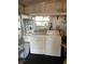 Functional laundry area with a washer, dryer, utility sink, shelving, and natural light at 533 Cervina N Dr # 773, Venice, FL 34285