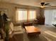 Bright living room with neutral-toned furniture, carpet, and natural light from windows at 533 Cervina N Dr # 773, Venice, FL 34285