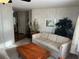 Comfortable living room with neutral decor, soft carpet, and natural light from windows at 533 Cervina N Dr # 773, Venice, FL 34285