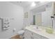 Bright bathroom featuring white fixtures, tile flooring, framed art, and a shower/tub combo at 5725 Greenwood Ave # 1201, North Port, FL 34287