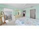 Bedroom featuring bed and large dresser with a screened-in porch with furniture visible through sliding glass doors at 5725 Greenwood Ave # 1201, North Port, FL 34287