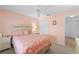 Cozy bedroom featuring carpet, a ceiling fan, and neutral peach walls, offering comfort at 5725 Greenwood Ave # 1201, North Port, FL 34287