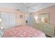 Bright bedroom featuring peach walls, carpet flooring, a ceiling fan, and closet for ample storage at 5725 Greenwood Ave # 1201, North Port, FL 34287