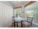 Cozy breakfast nook with a glass top table, two chairs, and bright windows for natural light at 5725 Greenwood Ave # 1201, North Port, FL 34287