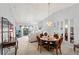 Open-concept dining area with modern light fixture next to living room at 5725 Greenwood Ave # 1201, North Port, FL 34287