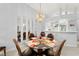 Dining room featuring glass-top table next to a kitchen bar and mirrored wall at 5725 Greenwood Ave # 1201, North Port, FL 34287