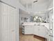 Open concept kitchen with white cabinets and tile flooring, flowing into the main living area at 5725 Greenwood Ave # 1201, North Port, FL 34287