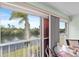 Enclosed lanai offering scenic views of a lake, with seating around a glass-topped table at 5725 Greenwood Ave # 1201, North Port, FL 34287