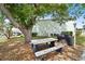 Shaded picnic area with a table, benches, and grill for outdoor dining at 5725 Greenwood Ave # 1201, North Port, FL 34287