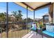 Screened lanai features cozy seating area with scenic views of the community and tennis courts at 612 Bird Bay S Dr # 311, Venice, FL 34285