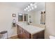 Bathroom features a vanity with granite counters, wood cabinets, and updated fixtures at 612 Bird Bay S Dr # 311, Venice, FL 34285