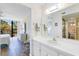Bathroom vanity area leads to bedroom with view of exterior through large window at 612 Bird Bay S Dr # 311, Venice, FL 34285