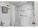 Bathroom with ceramic tile and white grout, walk-in shower with bench and handrails at 612 Bird Bay S Dr # 311, Venice, FL 34285
