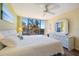 Bright bedroom features a large window with an exterior view, dresser with mirror, and wood flooring at 612 Bird Bay S Dr # 311, Venice, FL 34285