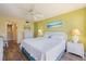 Bright bedroom features ceiling fan, dresser, and ensuite bath access at 612 Bird Bay S Dr # 311, Venice, FL 34285