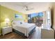 Bright bedroom with view of exterior through large windows, ceiling fan, and ensuite bath access at 612 Bird Bay S Dr # 311, Venice, FL 34285