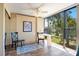 Bedroom features a convenient desk area, a large window, and hardwood floors at 612 Bird Bay S Dr # 311, Venice, FL 34285