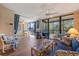 Inviting living room with wood floors, ceiling fan, comfortable furniture, and balcony access at 612 Bird Bay S Dr # 311, Venice, FL 34285
