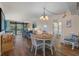 Open-concept living space with a dining area, comfortable seating, and access to a screened balcony with a view at 612 Bird Bay S Dr # 311, Venice, FL 34285