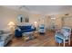 Bright living room features wood floors, ceiling fan, and tasteful decor with access to dining area at 612 Bird Bay S Dr # 311, Venice, FL 34285
