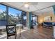 Bright living room featuring wood floors, balcony access, and comfortable seating area at 612 Bird Bay S Dr # 311, Venice, FL 34285