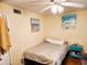 A quaint bedroom offers beachy décor and wood-look flooring for a relaxing ambiance at 616 Guild Dr # 2, Venice, FL 34285