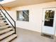 Exterior view of unit entrance with small stairs, window, and 'Home' welcome mat at 616 Guild Dr # 2, Venice, FL 34285