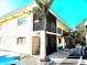 Exterior shot of condo with palm tree, balcony, stairs, and convenient parking at 616 Guild Dr # 2, Venice, FL 34285