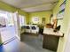 Shared laundry room with two washing machines and a countertop for folding laundry at 616 Guild Dr # 2, Venice, FL 34285