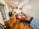 Living room with wood-look floors, ceiling fan, dining table, and doorway to other rooms at 616 Guild Dr # 2, Venice, FL 34285