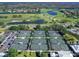 Aerial view showcasing the tennis courts, golf course, and surrounding community landscape at 643 Crossfield Cir # 13, Venice, FL 34293