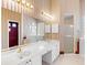 Bathroom showcasing double sinks, vanity, tub, and separate shower, with patterned wallpaper at 643 Crossfield Cir # 13, Venice, FL 34293