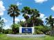 Entrance sign for Plantation Golf & Country Club, surrounded by manicured landscaping and palm trees at 643 Crossfield Cir # 13, Venice, FL 34293