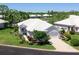 Beautiful white single-story home with lush landscaping and a well-manicured lawn at 643 Crossfield Cir # 13, Venice, FL 34293