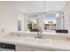 Open kitchen features a peninsula with seating, offering views of the backyard and waterfront at 643 Crossfield Cir # 13, Venice, FL 34293