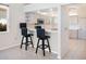 Well-lit kitchen with stainless steel appliances, and ample cabinet space with tile flooring at 643 Crossfield Cir # 13, Venice, FL 34293