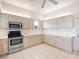 Modern kitchen features stainless steel appliances, ample counter space, and tiled flooring at 643 Crossfield Cir # 13, Venice, FL 34293
