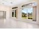 Bright living room with tile flooring, ceiling fan, and a serene view of the backyard waterfront at 643 Crossfield Cir # 13, Venice, FL 34293