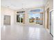 Sunlit living room showcases tile floors, ceiling fan and large windows with tranquil waterfront view at 643 Crossfield Cir # 13, Venice, FL 34293