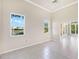 Open living room with large windows, tile floors and a view of the water at 643 Crossfield Cir # 13, Venice, FL 34293