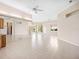 Spacious living room with neutral walls, tile flooring, and plentiful natural light at 643 Crossfield Cir # 13, Venice, FL 34293