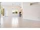 Bright, open living room features tile flooring, large windows, and an elegant chandelier at 643 Crossfield Cir # 13, Venice, FL 34293