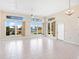 Bright living room boasts tile floors, a ceiling fan and expansive windows with picturesque lake views at 643 Crossfield Cir # 13, Venice, FL 34293