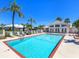 Community pool with lounge chairs and a clubhouse, perfect for relaxation and recreation at 643 Crossfield Cir # 13, Venice, FL 34293