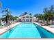 Community pool with lounge chairs and a clubhouse, perfect for relaxation and recreation at 643 Crossfield Cir # 13, Venice, FL 34293