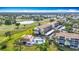 High angle aerial of condo complex surrounded by greenery and pond with golf course at 839 Wexford Blvd # 839, Venice, FL 34293