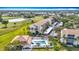 Aerial view of a condo complex, pool, golf course, and pond at 839 Wexford Blvd # 839, Venice, FL 34293